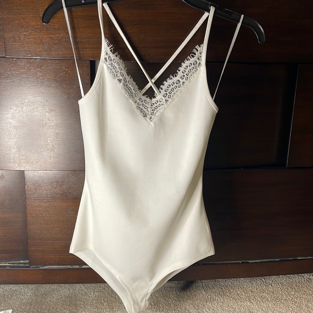 White body suit with criss crossed back in a size small from Discovery Clothing